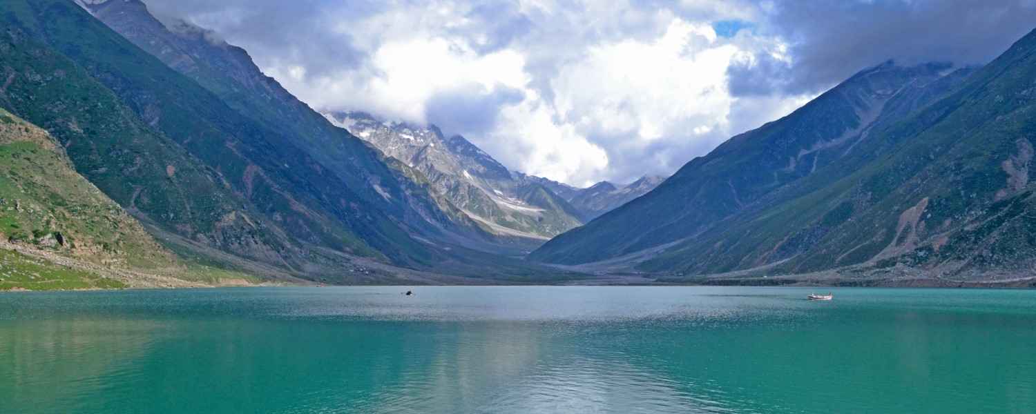 Calm Saif-ul-Malook lake between clouds and mountains